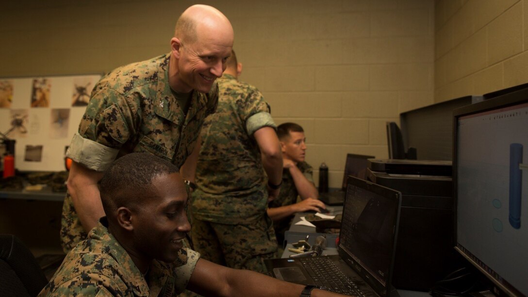 Col. Michael V. Samarov, commander of Special Purpose Marine Air-Ground Task Force - Southern Command, watches Lance Cpl. Eric C. Mitts, a water support technician with the Logistics Combat Element, SPMAGTF-SC, create a computer-aided design during the Three-dimensional Printing Training Course at Marine Corps Base Camp Lejeune, North Carolina, April 20, 2017. Marines from various sections of SPMAGTF-SC attended the two-day training hosted by General Support Maintenance Company, 2nd Maintenance Battalion, Combat Logistics Regiment 25, 2nd Marine Logistics Group, in order to gain hands-on experience with 3D printers and receive instruction in computer-aided design, file creation and manufacturing.