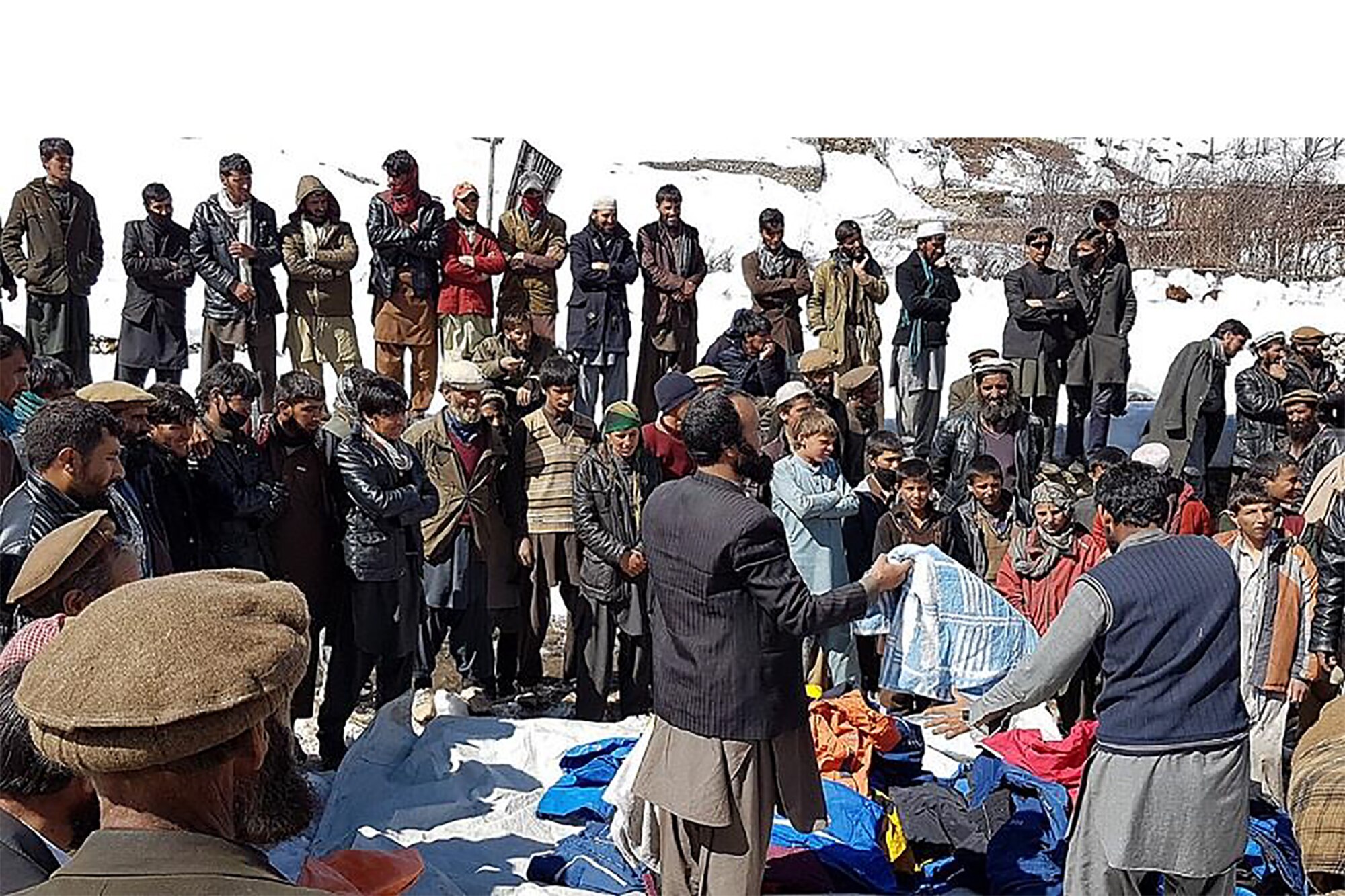 DEWA AND PRONS VILLIAGE, Afghanistan, 2016 – Children recieve winter supplies from the Lamia Afghan Foundation in Dewa and Prons village, Afghanistan, Mar. 5, 2016. People in these villages face many problems in the cold winter as they have no clothes and cover to protect themselves against harsh winter conditions. (Courtesy photo)

