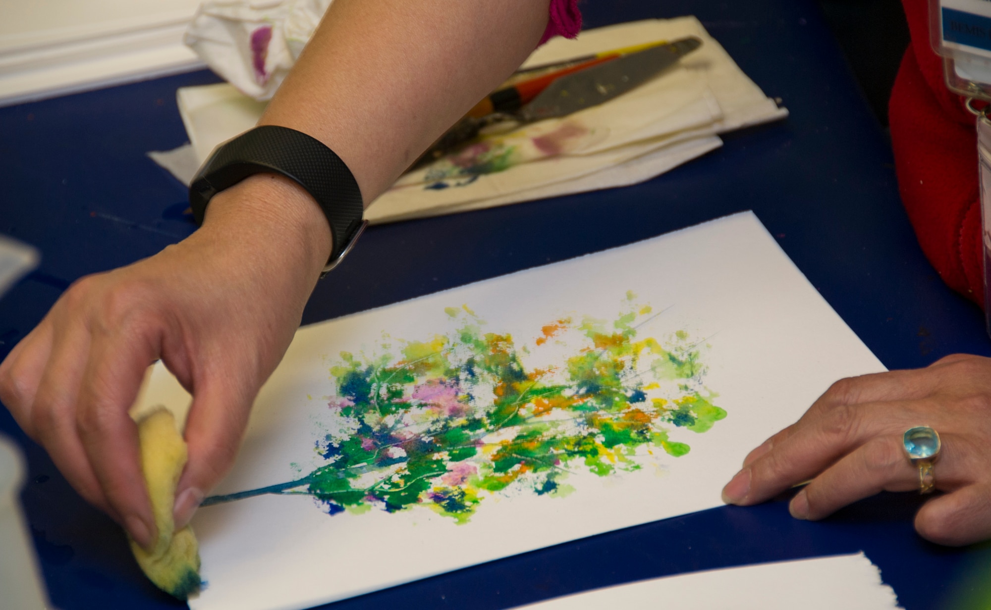 SCHRIEVER AIR FORCE BASE, Colo. -- Kim le Nguyen demonstrates how to create a tree with watercolors during an art therapy course at the Bemis School of Art in Colorado Springs on Friday, Apr. 21st, 2017. Nguyen teaches a Military Artistic Healing program at the Colorado Springs Fine Arts Center, using all forms of art to encourage healing among military members and their families.  (U.S. Air Force photo/Senior Airman Laura Turner)