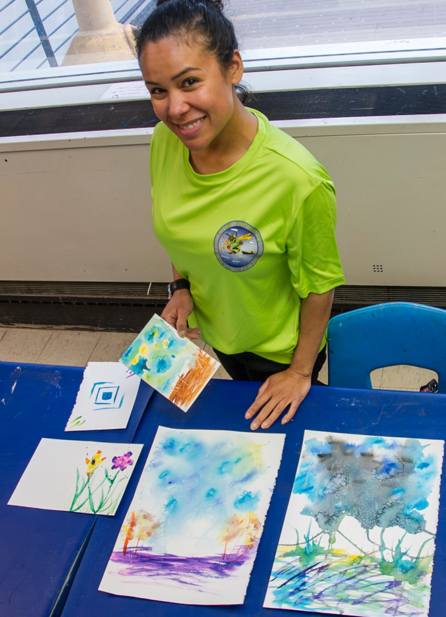 SCHRIEVER AIR FORCE BASE, Colo. -- Lt. Col. Morgenstarr Brienza, Air Force Space Command, poses with canvases she created during an art therapy class hosted by Kim le Nguyen at the Bemis School of Art in Colorado Springs on Friday, Apr. 21st, 2017. Nguyen teaches a Military Artistic Healing program at the Colorado Springs Fine Arts Center, using all forms of art to encourage healing among military members and their families.  (U.S. Air Force photo/Senior Airman Laura Turner)
