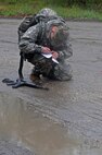 U.S. Army Reserve Sgt. Kevin Warren, 316th Mobility Augmentation Company, 844th Engineer Battalion , 926th Engineer Brigade, 412th Theater Engineer Command, is reflected in a pool of water as he double checks his map's point during the Combined Best Warrior Competition Land Navigation event on Joint Base McGuire-Dix-Lakehurst, N.J. April 4, 2017. Contestants hopefully take the title of Best Noncommissioned Officer or Best Soldier and move on to represent the 412th Theater Engineer Command,  416th Theater Engineer Command and 76th Operational Response at the USARC Best Warrior Competition. (U.S. Army Reserve Photo by Sgt. 1st Class Clinton Wood)
