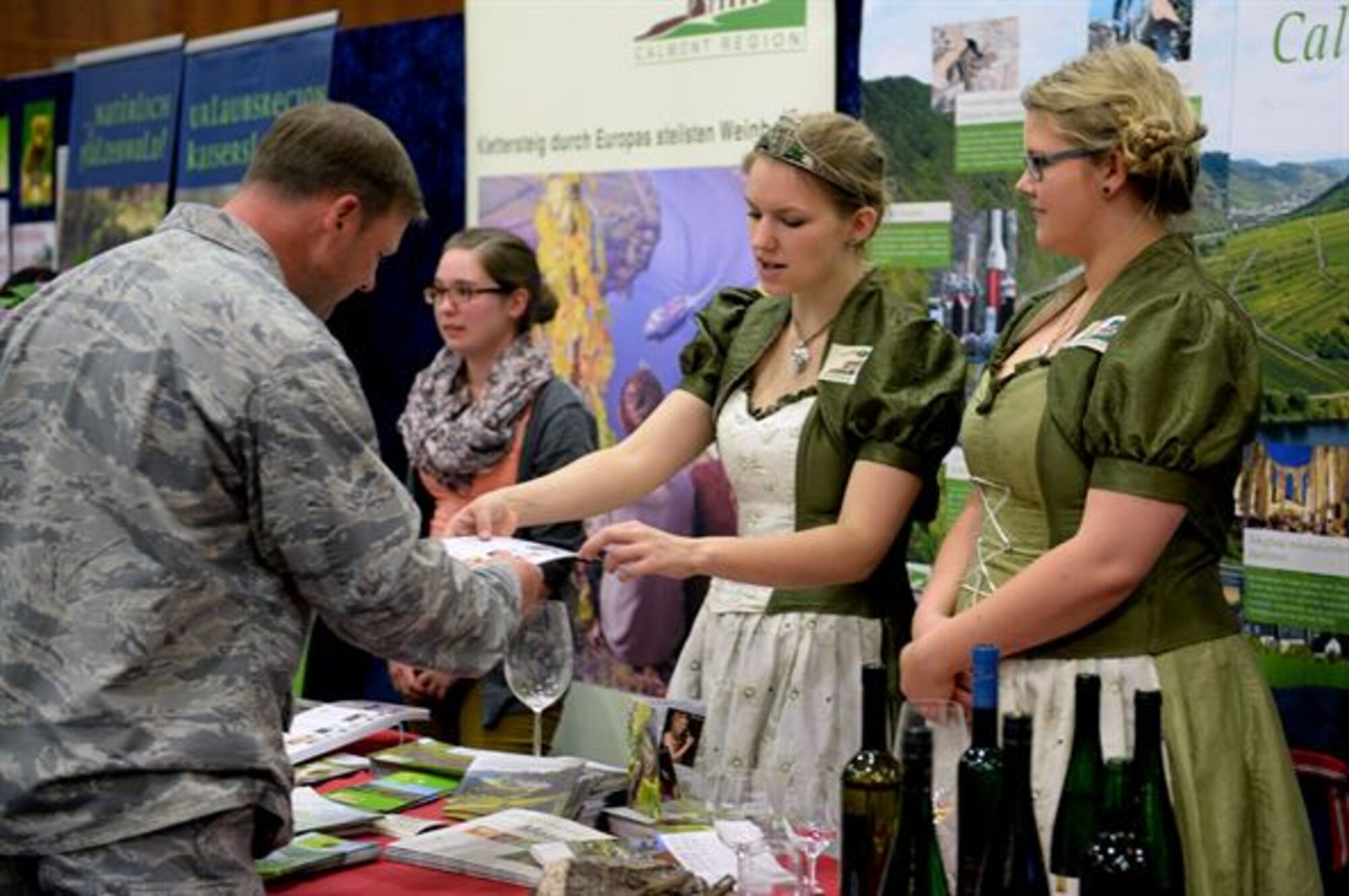 A participant at the 10th Annual Explore the Eifel Info and Adventure Fair learns about wine vineyards in the local area at Club Eifel on Spangdahlem Air Base, Germany, April 24, 2014. Exhibitors offered maps, information and food samples for their areas or businesses. (U.S. Air Force photo by Senior Airman Alexis Siekert/Released)