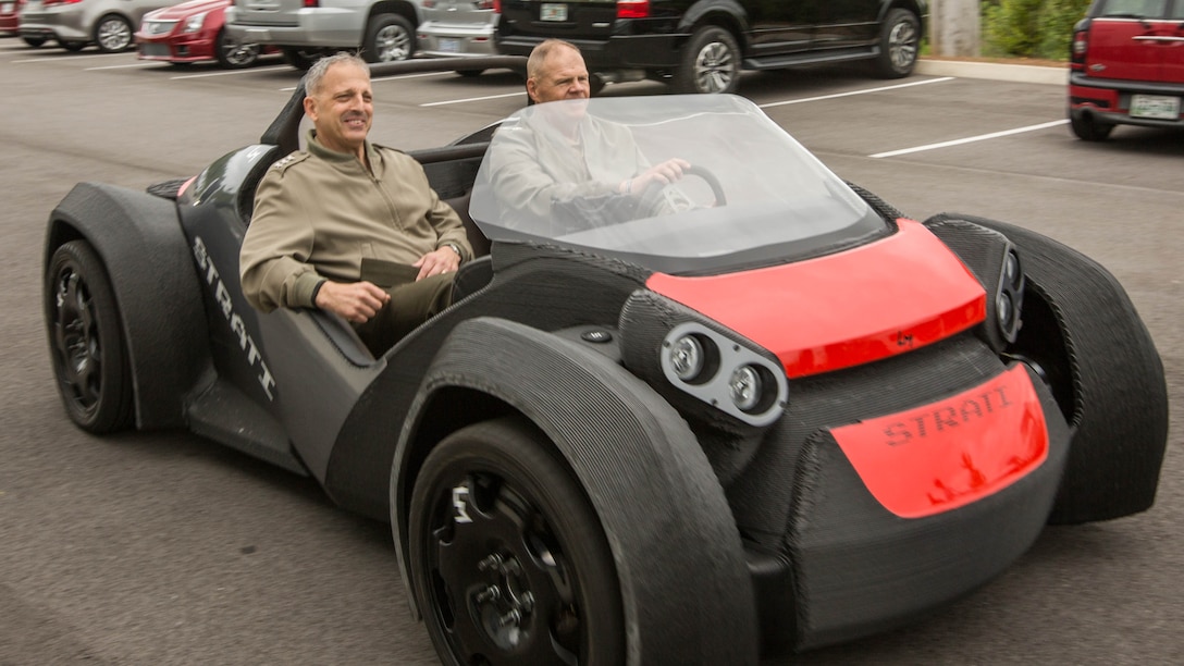 Commandant of the Marine Corps Gen. Robert B. Neller, right, and Lt. Gen. Michael G. Dana, deputy commandant of Installations and Logistics, ride in a 3D printed car at the Local Motors Microfactory, Knoxville, Tennessee, April 25, 2017. Neller and Dana visited to better understand innovative co-creation and manufacturing. 