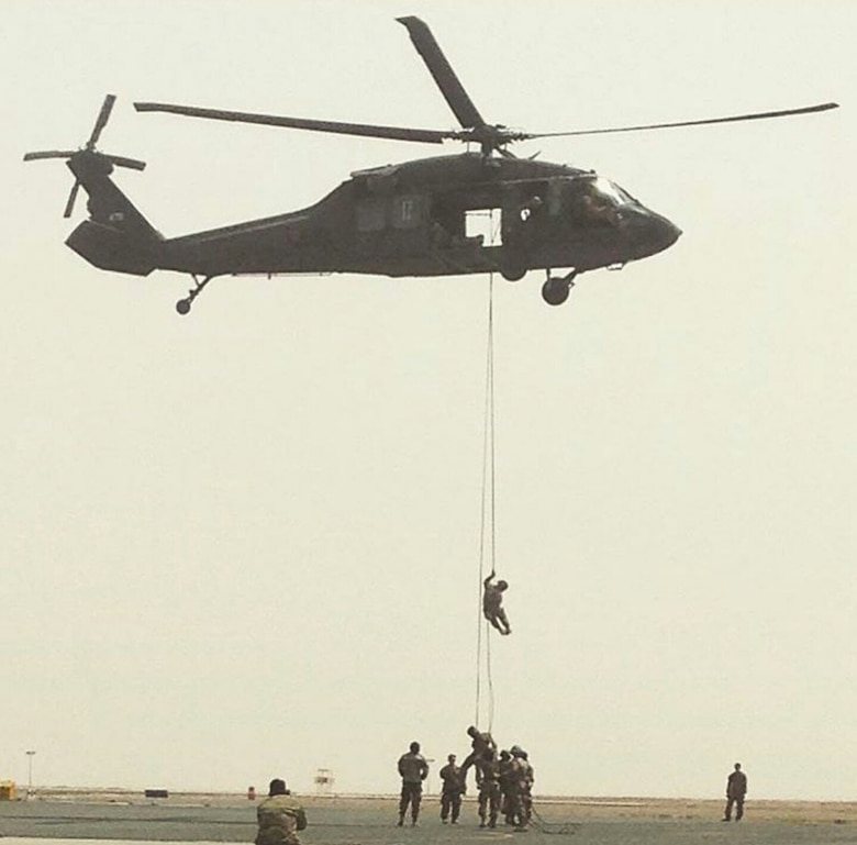 A student repels from a UH-60 Blackhawk during training at the U.S. Army Air Assault School at Camp Buehring, Kuwait on April 13, 2017. The 10-day course teaches techniques for insertion, pathfinder and evacuation operations involving helicopters. (Courtesy photo)