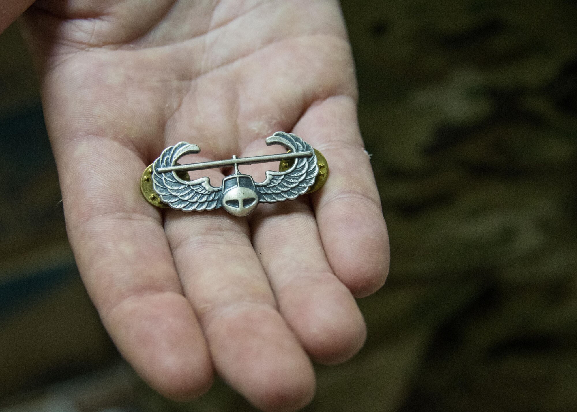 Senior Airman Domenic Martino, a 386th Air Expeditionary Wing civil engineering squadron explosive ordnance disposal technician, shows the U.S. Army Air Assault School pin he received after graduating from the course. This course was only recently offered in the area of responsibility and Martino was one of the first Airmen to graduate from the course. (U.S. Air Force photo/Staff Sgt. Andrew Park)
