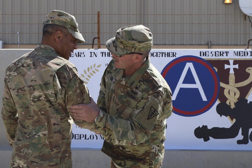 Lt. Gen. Michael Garrett, commanding general of U.S. Army Central greets Maj. Gen. William Lee, commanding general of 3rd medical Command (Deployment Support) during a brief site visit of a painted mural to celebrate 25 years of partnership between the two commands, April 21 at Camp As Sayliyah. 3rd Medical Command was reflagged in 1991 to provide support and valuable healthcare for Soldiers within ARCENT. (U.S. Army photo by Sgt. Bethany Huff, ARCENT Public Affairs)