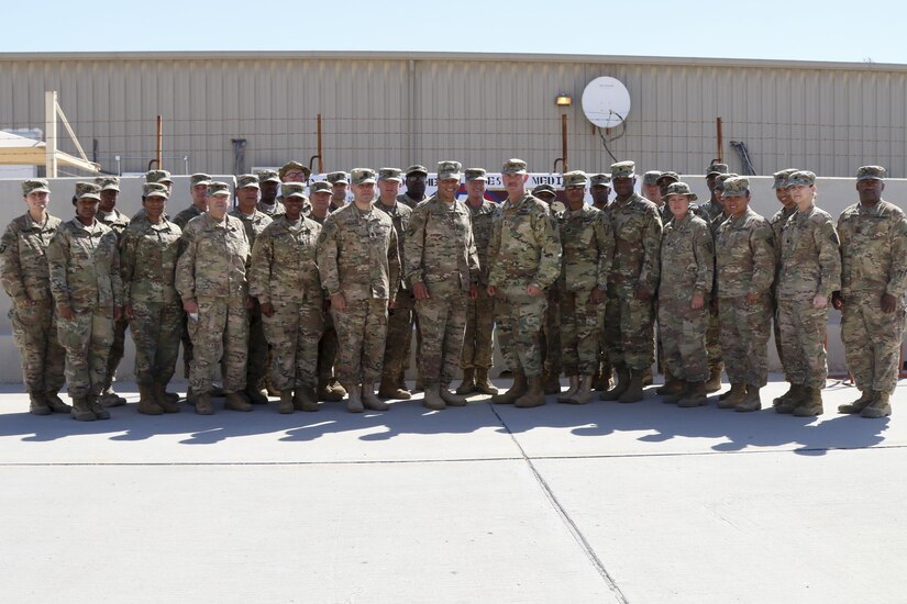 Lt. Gen. Michael Garrett, commanding general of U.S. Army Central and Maj. Gen. William Lee, commanding general of 3rd medical Command stand with the Soldiers of the 3rd Medical Command (Deployment Support) stationed in Qatar to celebrate 25 years of partnership, April 21 at Camp As Sayliyah. The 3rd Medical Command painted a barrier providing a physical tribute to the partnership between the two commands. (U.S. Army photo by Sgt. Bethany Huff, ARCENT Public Affairs)