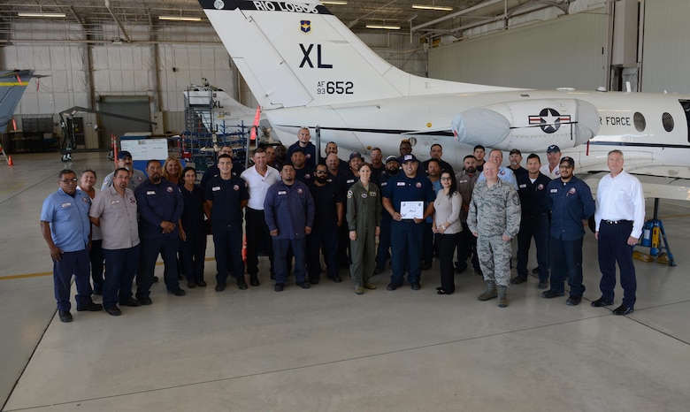 Israel Levrie, 47th Maintenance Directorate aircraft mechanic (center), accepts the “XLer of the Week” award from Col. Michelle Pryor, 47th Flying Training Wing vice commander (left), and Chief Master Sgt. Eric Hall, 47th Medical Group superintendent (right), on Laughlin Air Force Base, Texas, April 20, 2017. The XLer is a weekly award chosen by wing leadership and is presented to those who consistently make outstanding contributions to their unit and Laughlin. (U.S. Air Force photo/Airman 1st Class Benjamin N. Valmoja)