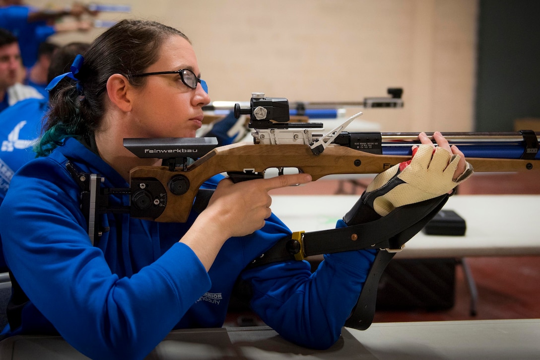 Airman Eleanor Carlin takes aim during a shooting session at the adaptive sports camp at Eglin Air Force Base, Fla., April 25, 2017. The base hosted recovering wounded, ill and injured military members for specific hands-on rehabilitative training for a shot at the 2017 Department of Defense Warrior Games. Air Force photo by Samuel King Jr.