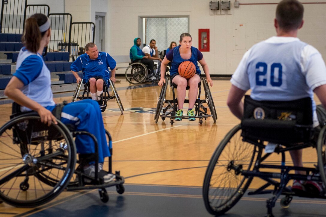 An athlete tries to make a pass during wheelchair basketball at the adaptive sports camp at Eglin Air Force Base, Fla., April 25, 2017. Air Force photo by Samuel King Jr.