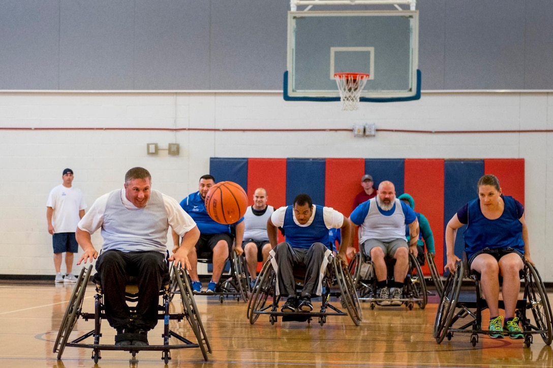 An athlete races to catch up to a loose ball during the wheelchair basketball session of the adaptive sports camp at Eglin Air Force Base, Fla., April 25, 2017. Air Force photo by Samuel King Jr.