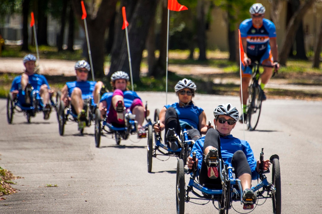 Airman Eleanor Carlin leads athletes on recumbent bicycle during a cycling session at the adaptive sports camp at Eglin Air Force Base, Fla., April 25, 2017. Air Force photo by Samuel King Jr.