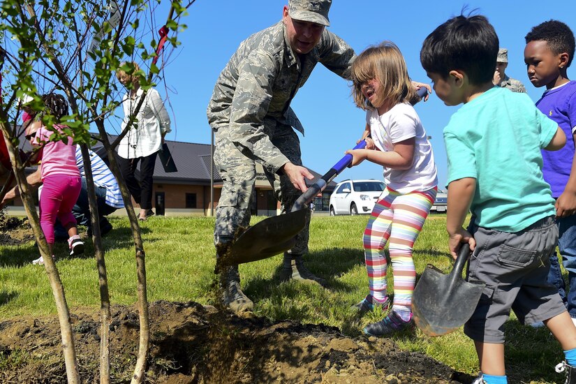 U.S. Air Force Col. David Stanfield, 633rd Mission Support Group commander, helps students at the Child Development Center plant trees during an Arbor Day event at Joint Base Langley-Eustis, Va., April 21, 2017. Trees benefit the earth by providing cleaner air, lowering energy costs, improving water quality, storm water control and increased property values. (U.S. Air Force photo/Senior Airman Derek Seifert)