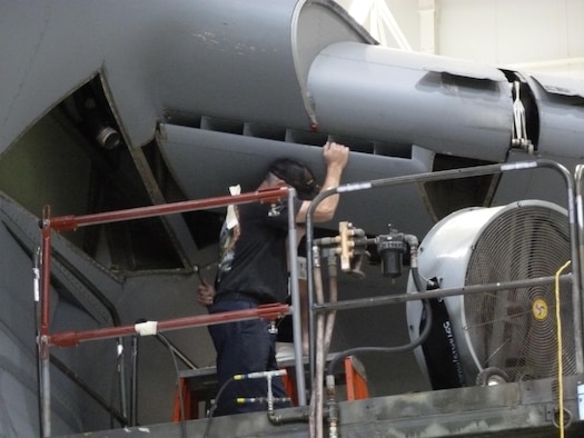 A maintainer removes an air inlet on the underside of the wing of a C-5M Super Galaxy Transport Aircraft during a periodic maintenance cycle. The Air Force Research Laboratory’s Advanced Power Technology Office is in the process of testing a new, lightweight composite RAM Air Inlet system that is intended to replace legacy air inlets, mitigating corrosion issues while providing a lightweight, cost-effective solution to help maintain the fleet. (U.S. Air Force courtesy photo)