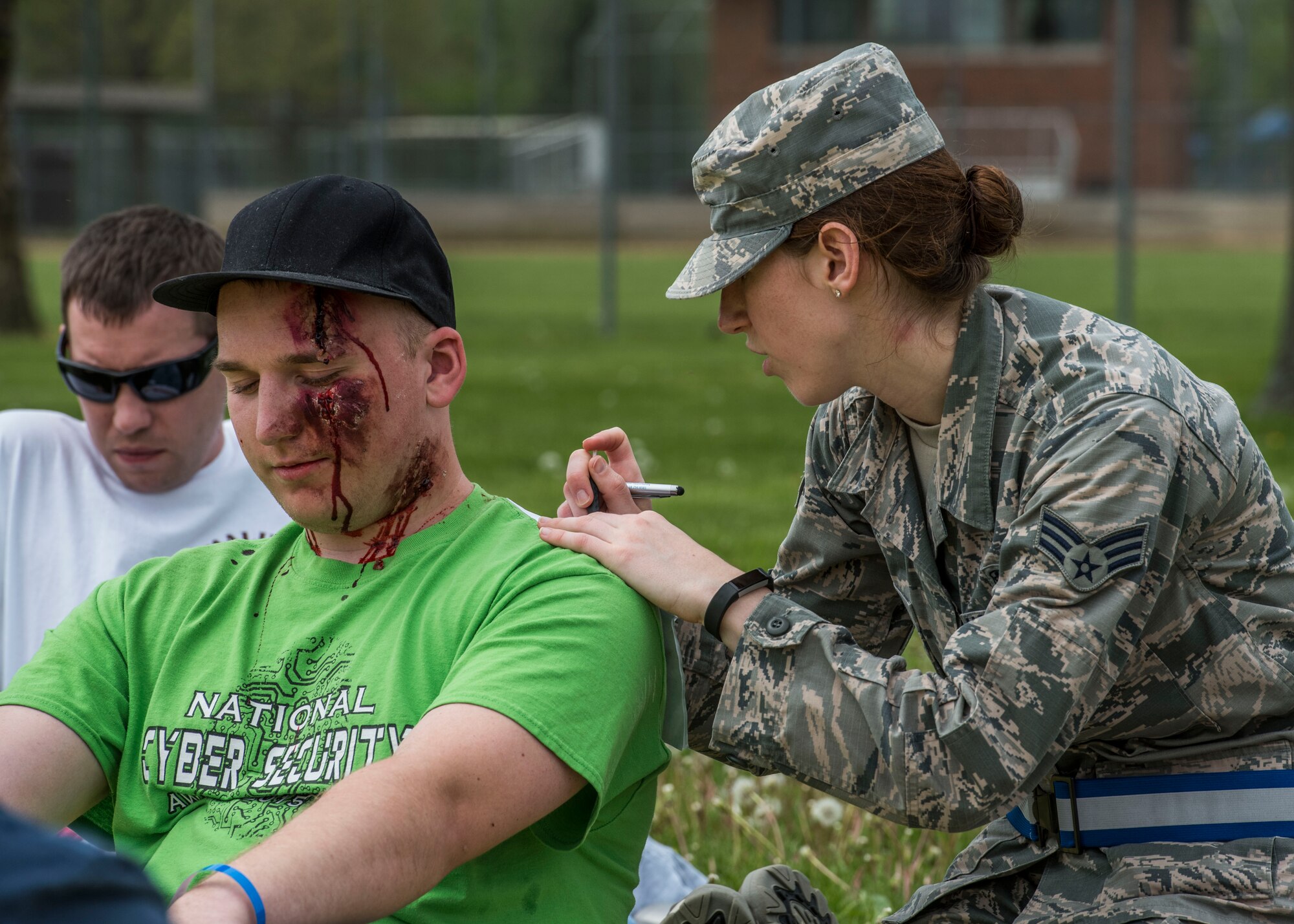Senior Airman Christen Tadaj, 375th Medical Operations Squadron, collects personal information from a simulated crash patient used during an exercise, Scott Air Force Base, Ill., April 20, 2017.  The exercise prepared Scott Air Force Base personnel for air show incident response.  First responders managed over 70 patients and practiced their procedures in the event of an aircraft accident.   (U.S. Air Force photo by Staff Sgt. Jodi Martinez)