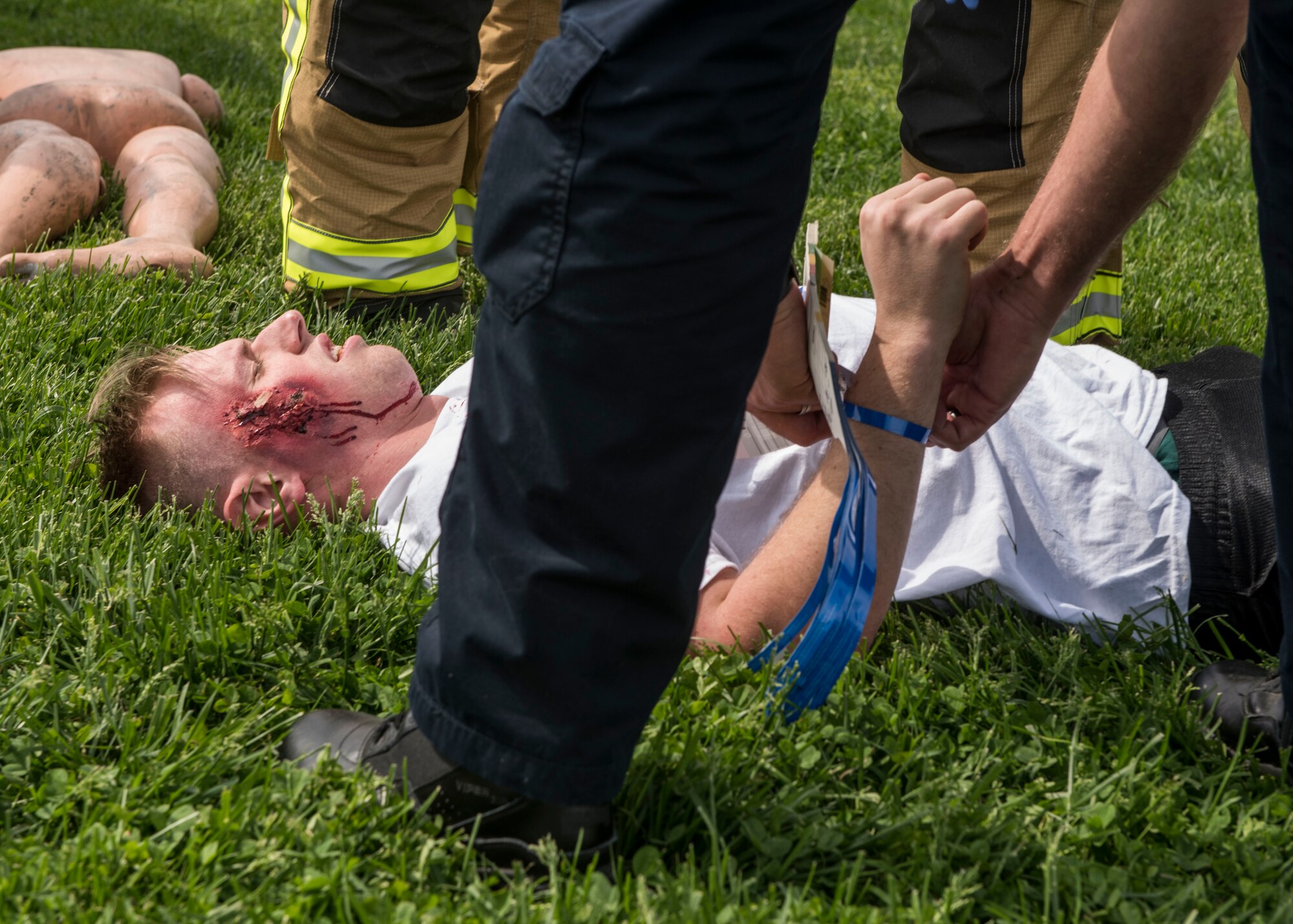 Medical personnel tend to patients during an exercise that tested Scott personnel on their emergency reactions to an air show, Scott Air Force Base, Ill., April 20, 2017.  The exercise prepared Scott Air Force Base personnel for air show incident response.  First responders managed over 70 patients and practiced their procedures in the event of an aircraft accident.