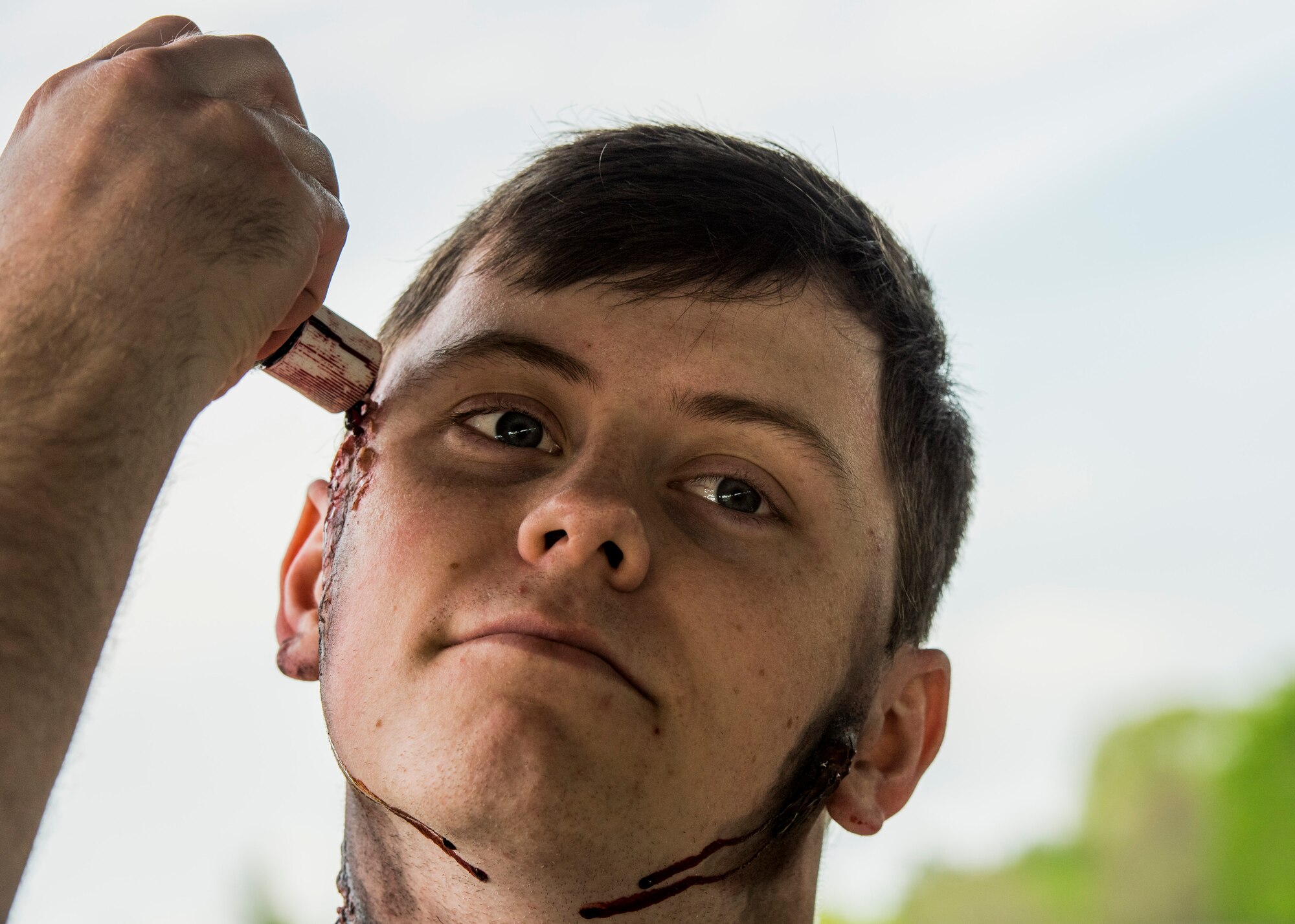 Senior Airman Michael Bowman, 375th Communications Support Squadron, prepares to be a simulated casualty during an exercise preparing Scott Air Force Base personnel for air show incident response, Scott Air Force Base, Ill., April 20, 2017.  Over 70 simulated patients helped test first responders on procedures in the events of an aircraft accident.  (U.S. Air Force photo by Staff Sgt. Jodi Martinez)