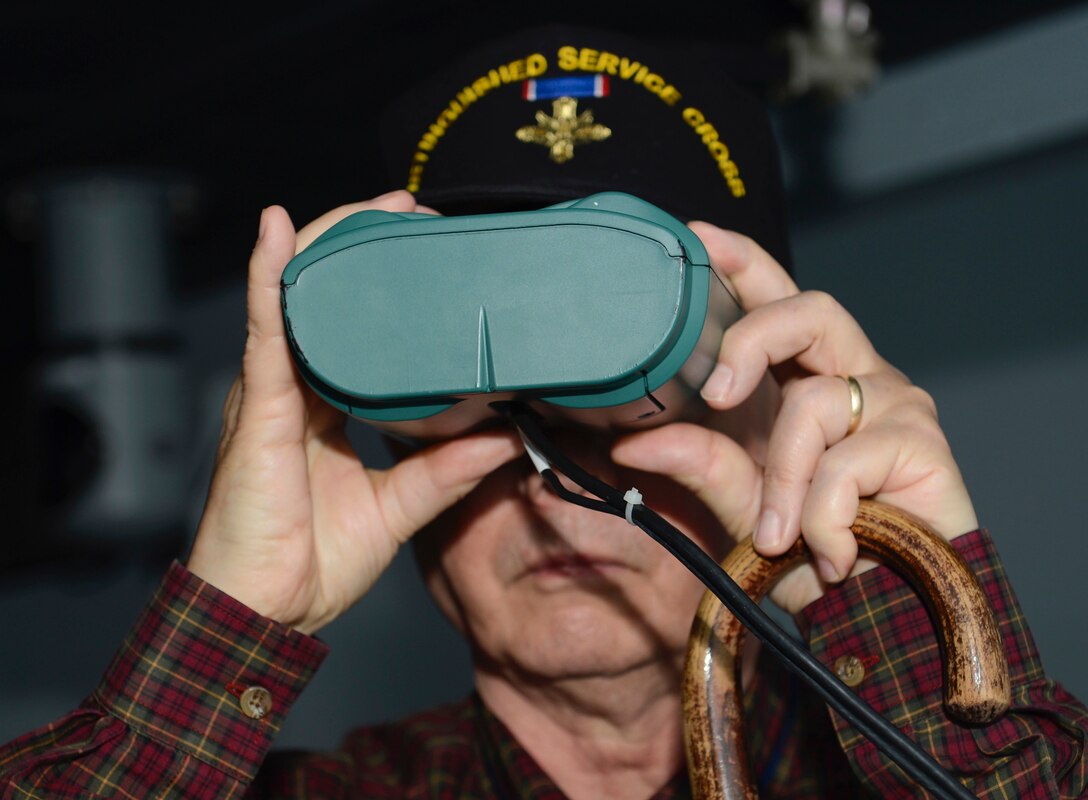 Retired U.S. Army 1st Sgt. Claude Quick, Legion of Valor member, looks through simulation binoculars at the Maritime Intermodal Training Department while on a tour at Joint Base Langley-Eustis, Va., April 21, 2017. Each year, members of the Legion of Valor gather for an annual convention to enhance their understanding of current military affairs and provide mentorship from personal accomplishments or failures. (U.S. Air Force photo/Airman 1st Class Kaylee Dubois)