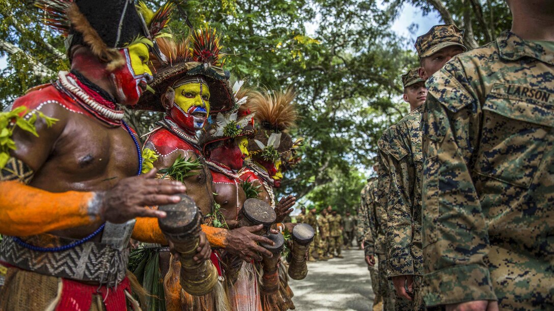 Papua New Guinean folk dancers line up with U.S. Marines and sailors during a banquet as part of a closing ceremony for a military tactics training exchange at Taurama Barracks, Papua New Guinea, April 18, 2017. Marines and sailors assigned to the 11th Marine Expeditionary Unit conducted the training with Papua New Guinea Defense Force service members. Marine Corps photo by Cpl. Devan K. Gowans