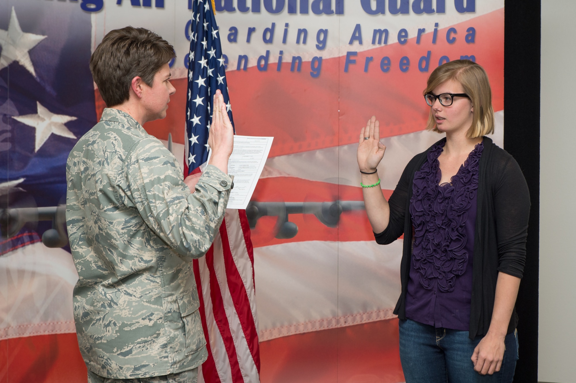 Alayna Stevenson recites the oath of enlistment, April 4, 2017 in Cheyenne, Wyoming. Stevenson's enlistment is a result from a home school event sponsored by the 153rd Recruiting and Retention office. (U.S. Air National Guard photo by Senior Master Sgt. Charles Delano/released)