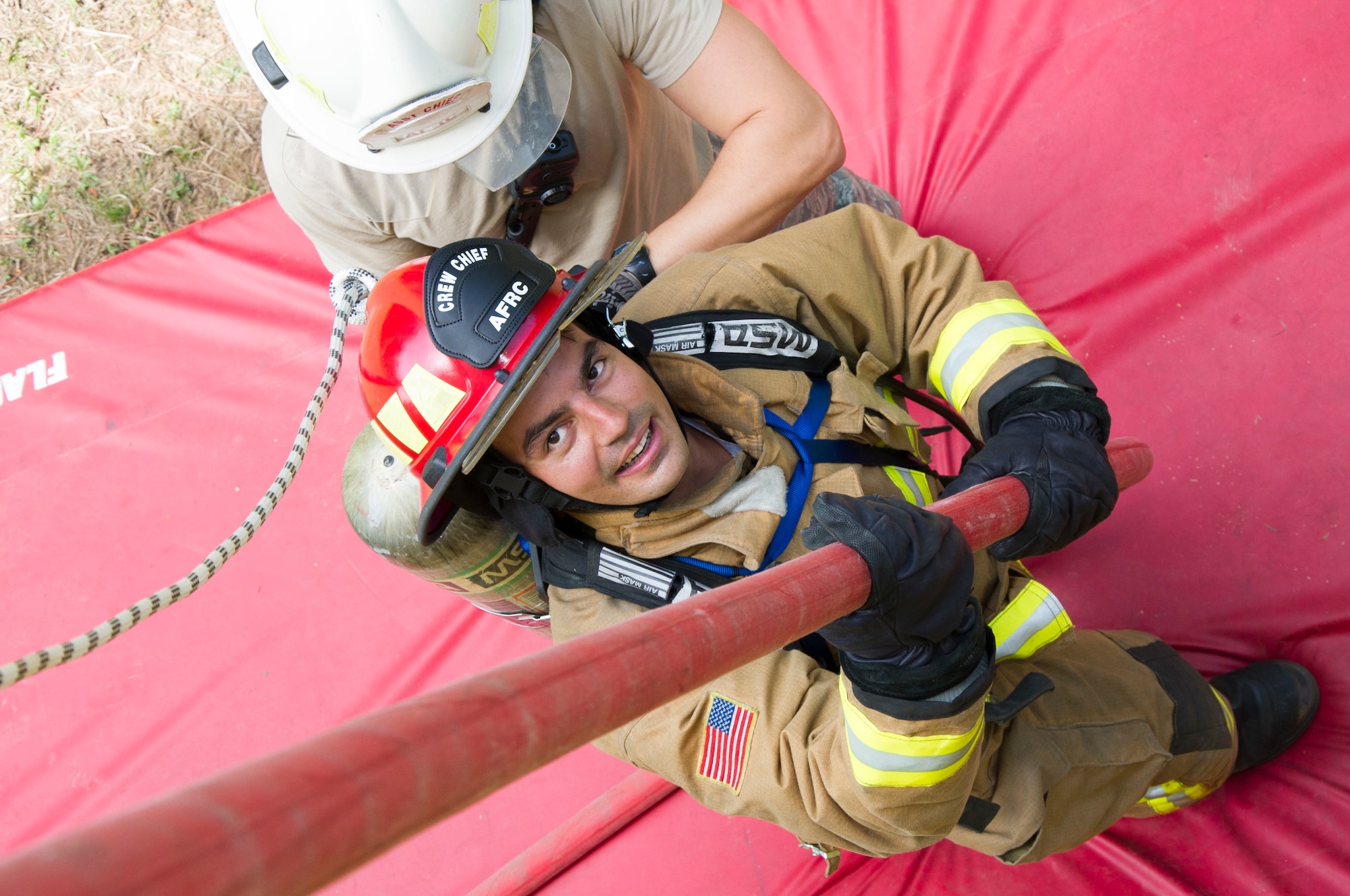 U.S. Air Force Tech. Sgt. Matthew Pires, from the island of Maui, and a member of the 624th Civil Engineer Squadron from Joint Base Pearl Harbor-Hickam, Hawaii, finishes his descent following a hoseline bailout during the first-ever Air Force Reserve Command Firefighter Rescue and Survival Course at Dobbins Air Reserve Base, Ga., April 18, 2017. Twenty Citizen Airmen participated in the intense 50-hour course held at the 622nd Civil Engineer Group expeditionary combat support-training certification center, which focused on a Rapid Intervention Crew, or RIC. The RIC is a dedicated and specially trained group of firefighters whose responsibilities include safely evacuating a distressed firefighter from a structure. (U.S. Air Force photo by Master Sgt. Theanne K. Herrmann)