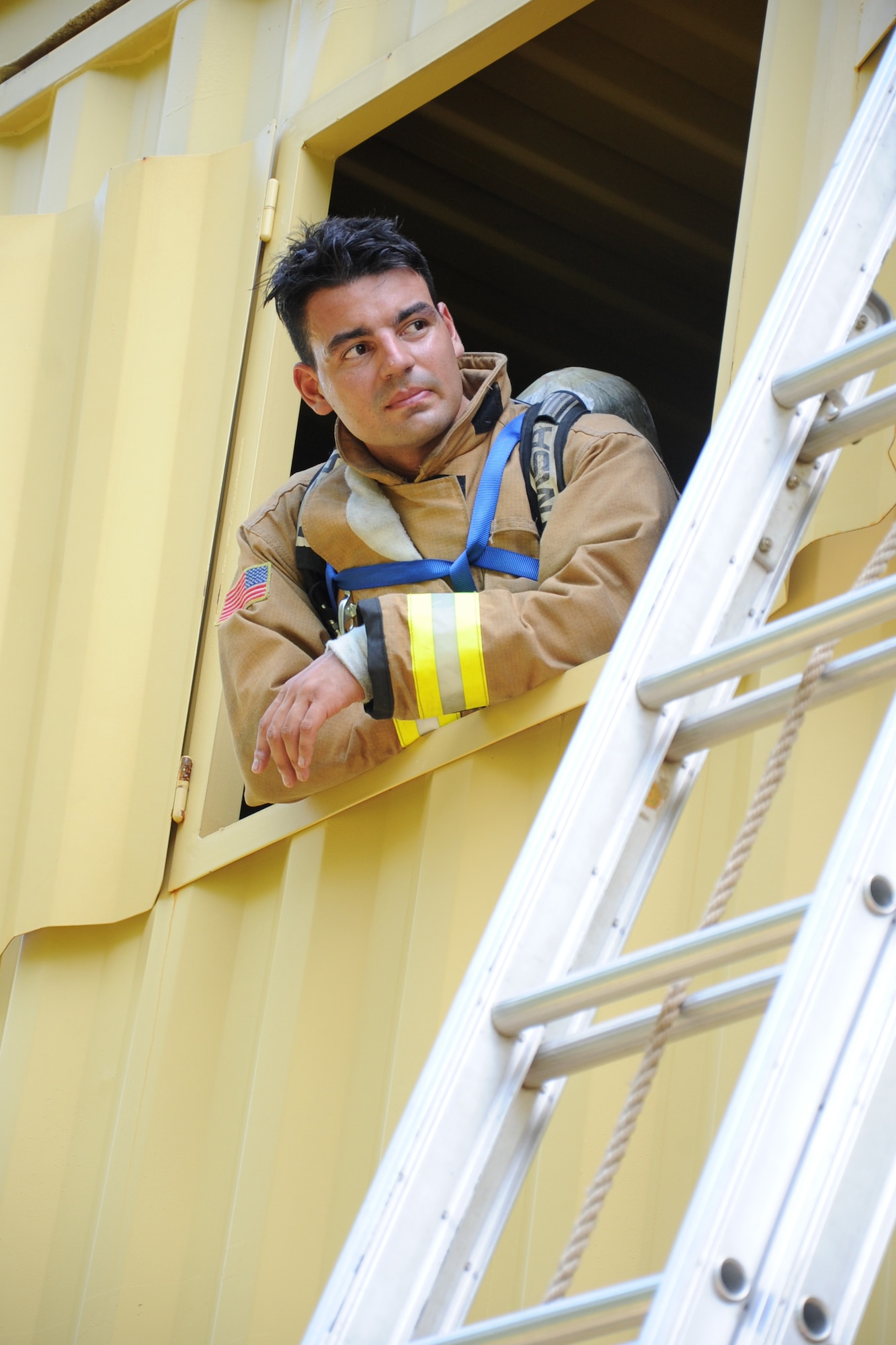 U.S. Air Force Tech. Sgt. Matthew Pires, a Citizen Airmen from the 624th Civil Engineer Squadron, Joint Base Pearl Harbor-Hickam, Hawaii, observes fellow firefighters bailout out of a simulated burning building during the first-ever Air Force Reserve Command Firefighter Rescue and Survival Course at Dobbins Air Reserve Base, Ga., April 18, 2017. Twenty Citizen Airmen participated in the intense 50-hour course held at the 622nd Civil Engineer Group expeditionary combat support-training certification center, which focused on a Rapid Intervention Crew, or RIC. The RIC is a dedicated and specially trained group of firefighters whose responsibilities include safely evacuating a distressed firefighter from a structure. (U.S. Air Force photo by Master Sgt. Theanne K. Herrmann)