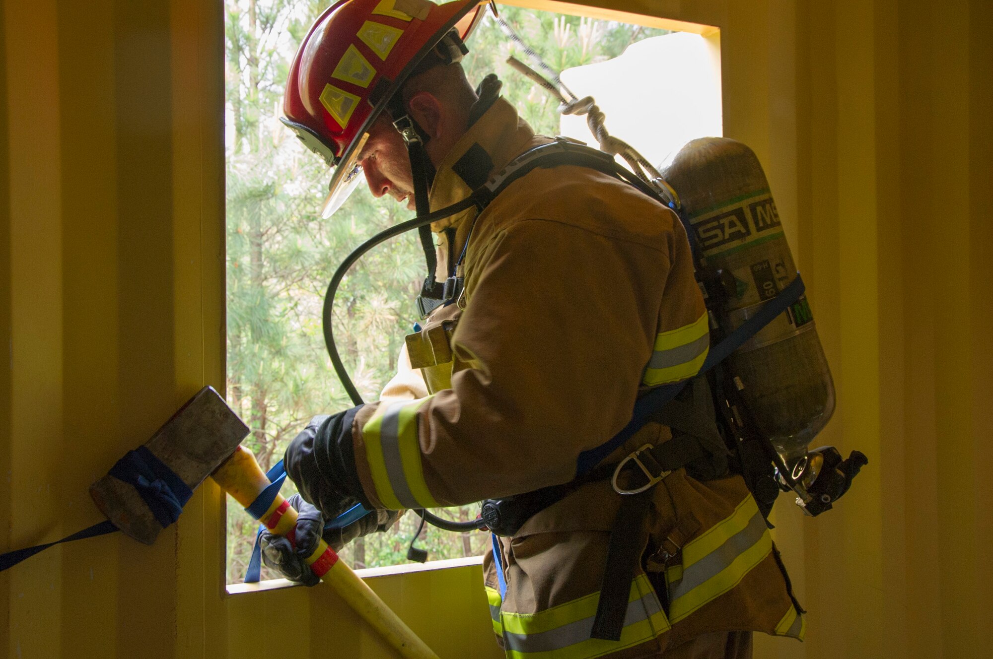 U.S. Air Force Tech. Sgt. Adam Murray from the 507th Civil Engineer Squadron, Tinker Air Force Base, Okla., uses an axe to practice a bailout technique from a simulated burning building during the first-ever Air Force Reserve Command Firefighter Rescue and Survival Course at Dobbins Air Reserve Base, Ga., April 18, 2017. Twenty Citizen Airmen participated in the intense 50-hour course held at the 622nd Civil Engineer Group expeditionary combat support-training certification center, which focused on a Rapid Intervention Crew, or RIC. The RIC is a dedicated and specially trained group of firefighters whose responsibilities include safely evacuating a distressed firefighter from a structure. (U.S. Air Force photo by Master Sgt. Theanne K. Herrmann)