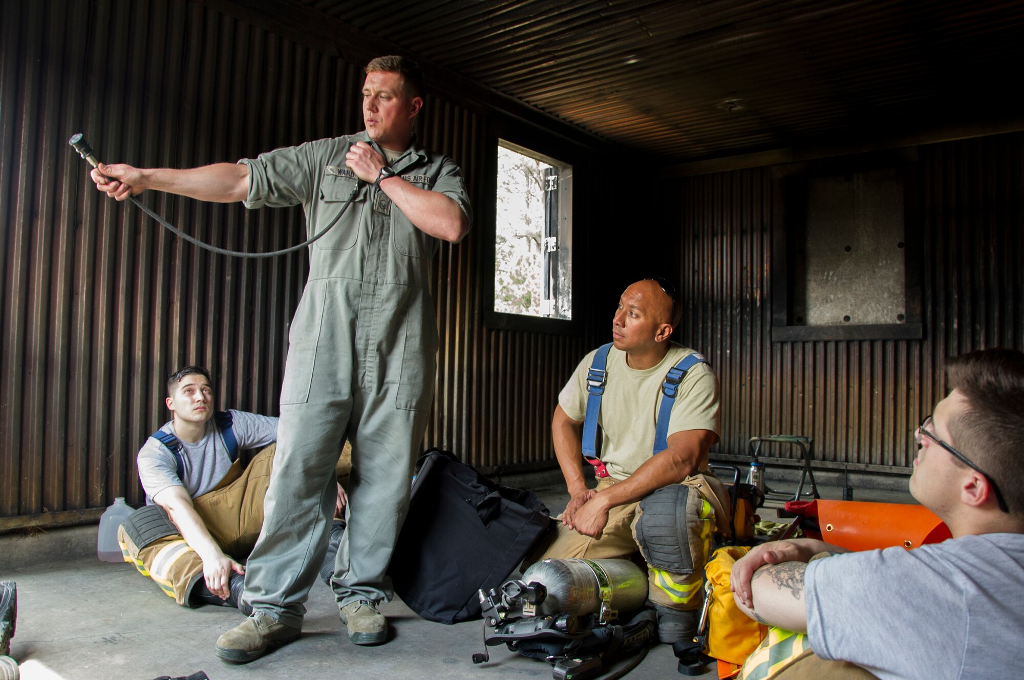 U.S. Air Force Master Sgt. Nick Ward, of Chicago, Illinois, a member of the 434th Civil Engineer Squadron, Grissom Air Reserve Base, explains how to hook up a hose from an empty air cylinder to a full cylinder during the first-ever Air Force Reserve Command Firefighter Rescue and Survival Course at Dobbins Air Reserve Base, Ga., April 18, 2017. Twenty Citizen Airmen participated in the intense 50-hour course held at the 622nd Civil Engineer Group expeditionary combat support-training certification center, which focused on a Rapid Intervention Crew, or RIC. The RIC is a dedicated and specially trained group of firefighters whose responsibilities include safely evacuating a distressed firefighter from a structure. (U.S. Air Force photo by Master Sgt. Theanne K. Herrmann)