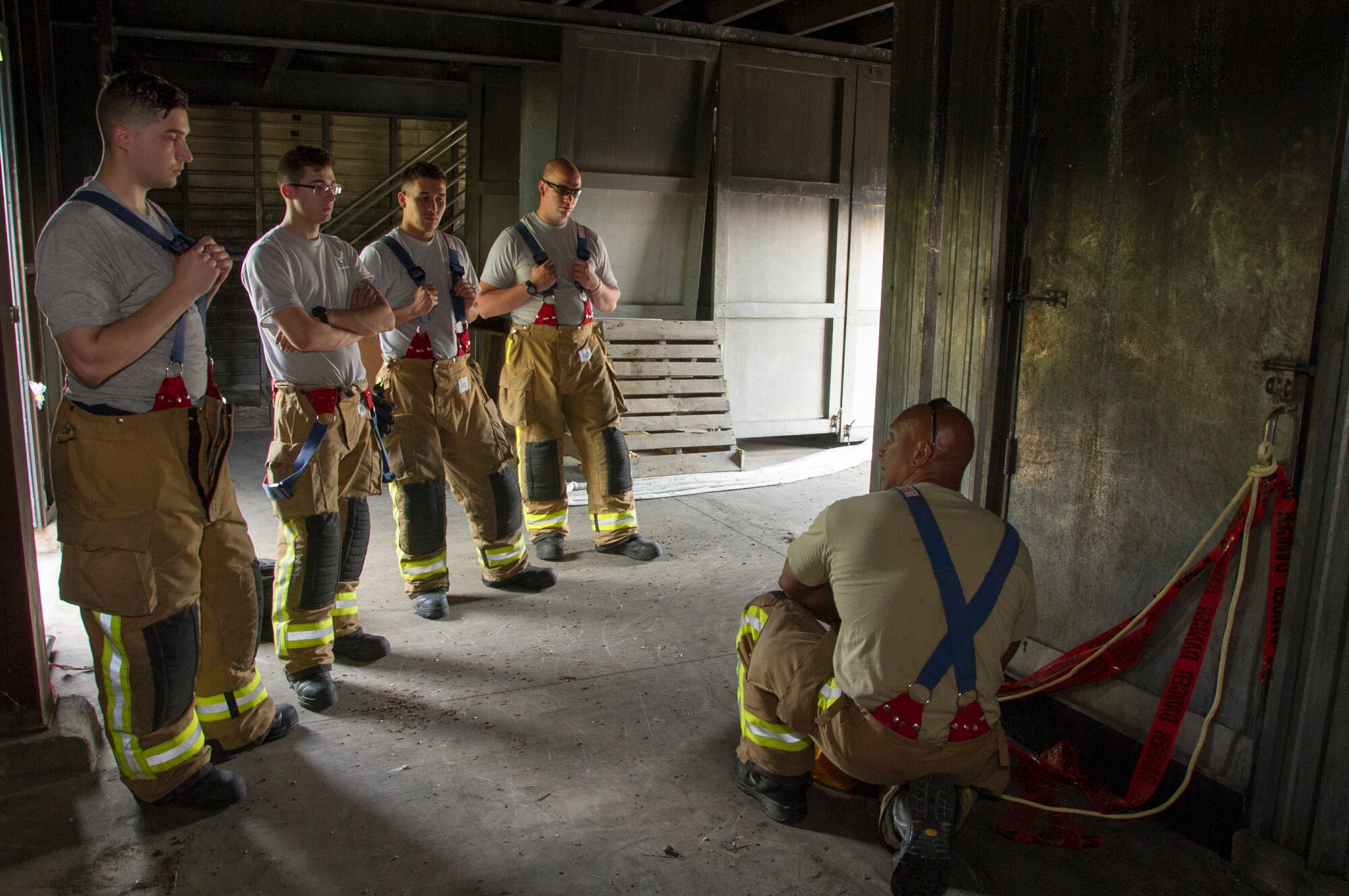 U.S. Air Force Master Sgt. Matthew Kaea, right, of Makakilo, Hawaii, a member of the 624th Civil Engineer Squadron from Joint Base Pearl Harbor-Hickam, Hawaii, explains how to maneuver through a simulated smoke-filled building using a tag line during the first-ever Air Force Reserve Command Firefighter Rescue and Survival Course at Dobbins Air Reserve Base, Ga., April 18, 2017. Twenty Citizen Airmen participated in the intense 50-hour course held at the 622nd Civil Engineer Group expeditionary combat support-training certification center, which focused on a Rapid Intervention Crew, or RIC. The RIC is a dedicated and specially trained group of firefighters whose responsibilities include safely evacuating a distressed firefighter from a structure. (U.S. Air Force photo by Master Sgt. Theanne K. Herrmann)