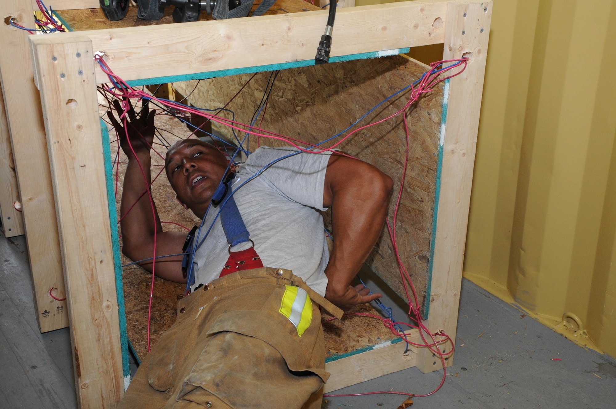 U.S. Air Force Master Sgt. Matthew Kaea, of Makakilo, Hawaii, a member of the 624th Civil Engineer Squadron from Joint Base Pearl Harbor-Hickam, Hawaii, demonstrates escape maneuvers using hanging wires and cables during the first-ever Air Force Reserve Command Firefighter Rescue and Survival Course at Dobbins Air Reserve Base, Ga., April 18, 2017. Twenty Citizen Airmen participated in the intense 50-hour course held at the 622nd Civil Engineer Group expeditionary combat support-training certification center, which focused on a Rapid Intervention Crew, or RIC. The RIC is a dedicated and specially trained group of firefighters whose responsibilities include safely evacuating a distressed firefighter from a structure. (U.S. Air Force photo by Master Sgt. Theanne K. Herrmann)