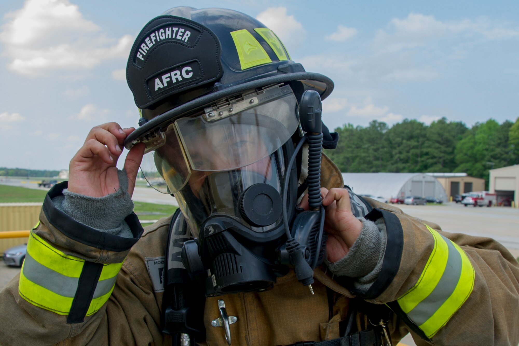 U.S. Air Force Senior Airman David Chaiprakorb, of Kaneohe, Hawaii, and a member of the 624th Civil Engineer Squadron, Joint Base Pearl Harbor-Hickam, Hawaii, prepares his mask during a smoke-filled building simulation to rescue a downed firefighter during the first-ever Air Force Reserve Command Firefighter Rescue and Survival Course at Dobbins Air Reserve Base, Ga., April 18, 2017. Twenty Citizen Airmen participated in the intense 50-hour course held at the 622nd Civil Engineer Group expeditionary combat support-training certification center, which focused on a Rapid Intervention Crew, or RIC. The RIC is a dedicated and specially trained group of firefighters whose responsibilities include safely evacuating a distressed firefighter from a structure. (U.S. Air Force photo by Master Sgt. Theanne K. Herrmann)