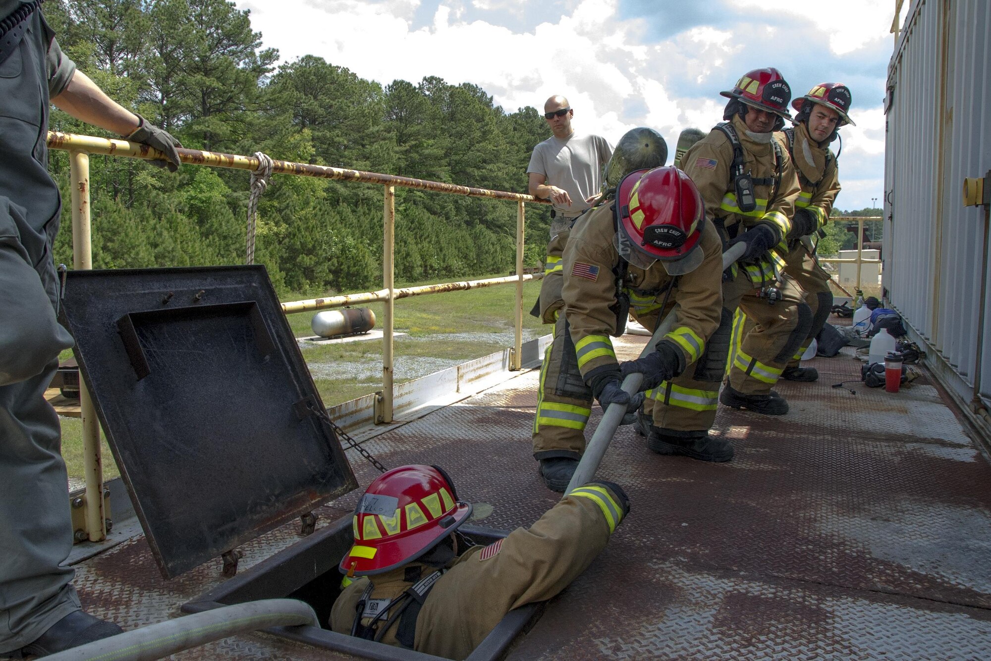A team of Air Force Reserve firefighters practice using the hoseline to rescue a firefighter from a simulated collapsed building during the first-ever Air Force Reserve Command Firefighter Rescue and Survival Course at Dobbins Air Reserve Base, Ga., April 18, 2017. Twenty Citizen Airmen participated in the intense 50-hour course held at the 622nd Civil Engineer Group expeditionary combat support-training certification center, which focused on a Rapid Intervention Crew, or RIC. The RIC is a dedicated and specially trained group of firefighters whose responsibilities include safely evacuating a distressed firefighter from a structure. (U.S. Air Force photo by Master Sgt. Theanne K. Herrmann)