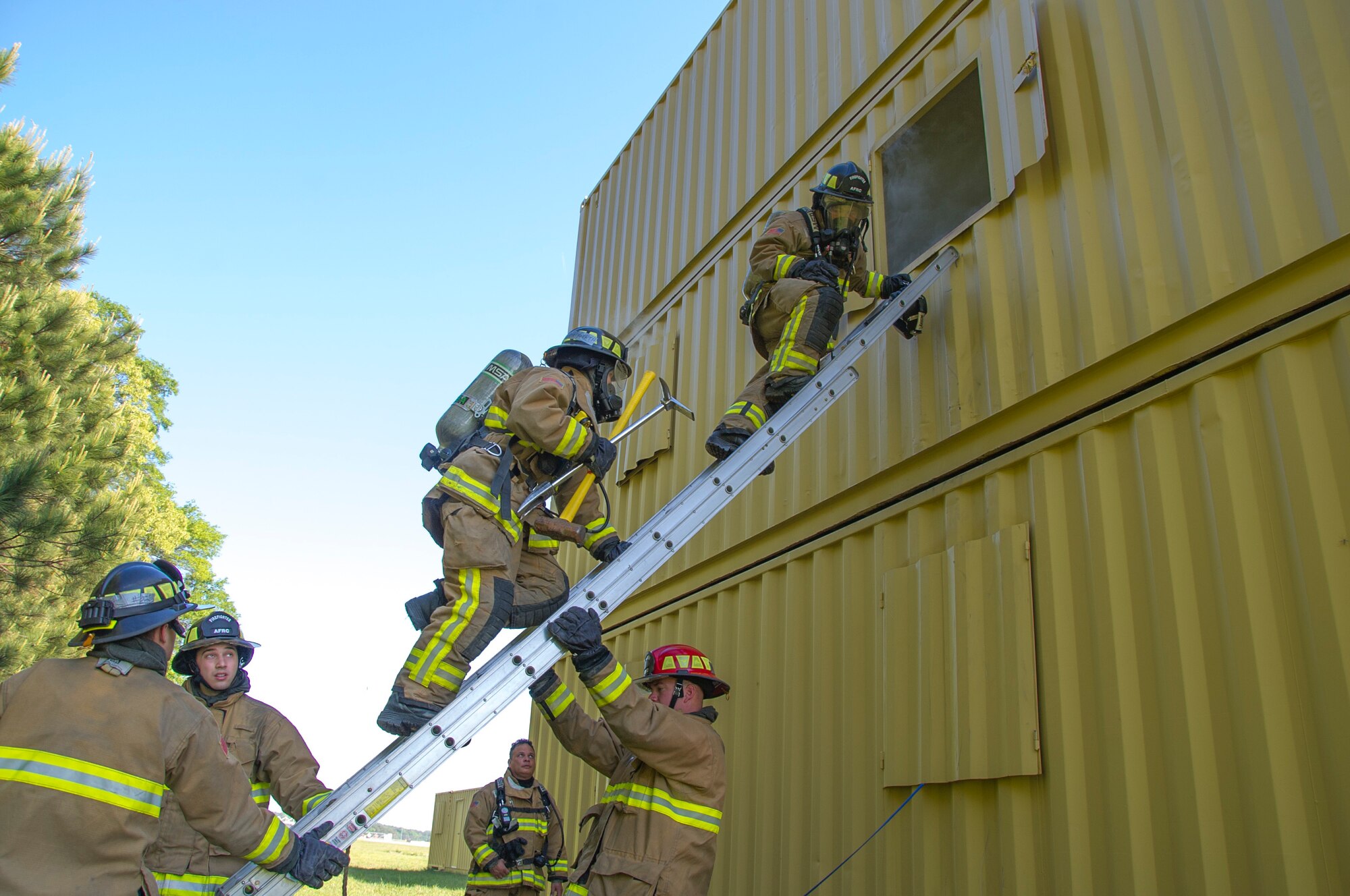 Air Force Reserve firefighters enter a building to rescue a downed firefighter during a training scenario for the first-ever Air Force Reserve Command Firefighter Rescue and Survival Course at Dobbins Air Reserve Base, Ga., April 18, 2017. Twenty Citizen Airmen participated in the intense 50-hour course held at the 622nd Civil Engineer Group expeditionary combat support-training certification center, which focused on a Rapid Intervention Crew, or RIC. The RIC is a dedicated and specially trained group of firefighters whose responsibilities include safely evacuating a distressed firefighter from a structure. (U.S. Air Force photo by Master Sgt. Theanne K. Herrmann)