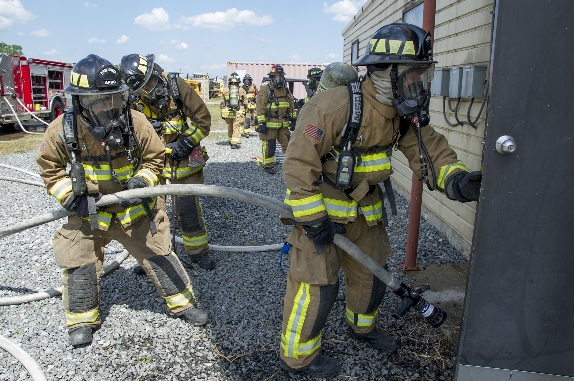 Air Force Reserve firefighters enter a building to extinguish a live fire during the first-ever Air Force Reserve Command Firefighter Rescue and Survival Course at Dobbins Air Reserve Base, Ga., April 18, 2017. Twenty Citizen Airmen participated in the intense 50-hour course held at the 622nd Civil Engineer Group expeditionary combat support-training certification center, which focused on a Rapid Intervention Crew, or RIC. The RIC is a dedicated and specially trained group of firefighters whose responsibilities include safely evacuating a distressed firefighter from a structure. (U.S. Air Force photo by Master Sgt. Theanne K. Herrmann)
