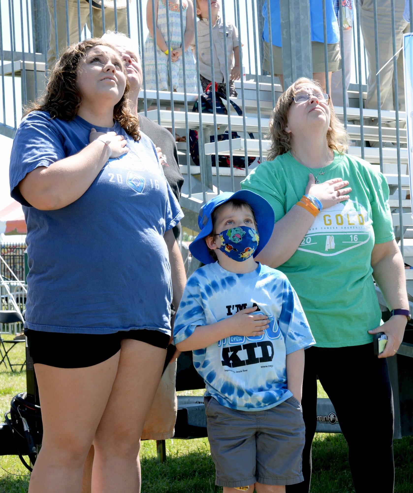 T.J. Esco, middle, and his family watch Air Force members parachute from an airplane during the Maxwell Air Show, April 9, 2017. Since being diagnosed with Acute Lymphoblastic Leukemia, T.J. would pretend to be a pilot and fly airplanes with his father during multiple hospital stays. (U.S. Air Force photo/Senior Airman Tammie Ramsouer)