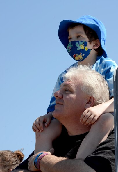 T.J. Esco, and his father, Tim Esco, watch acrobatic airplanes fly during the Maxwell Air Show, April 9, 2017. T.J. was diagnosed with Acute Lymphoblastic Leukemia in 2015, and has already had two full rounds of chemotherapy. He is currently in remission, but is continuing chemo medication for the next two years. (U.S. Air Force photo/Senior Airman Tammie Ramsouer)