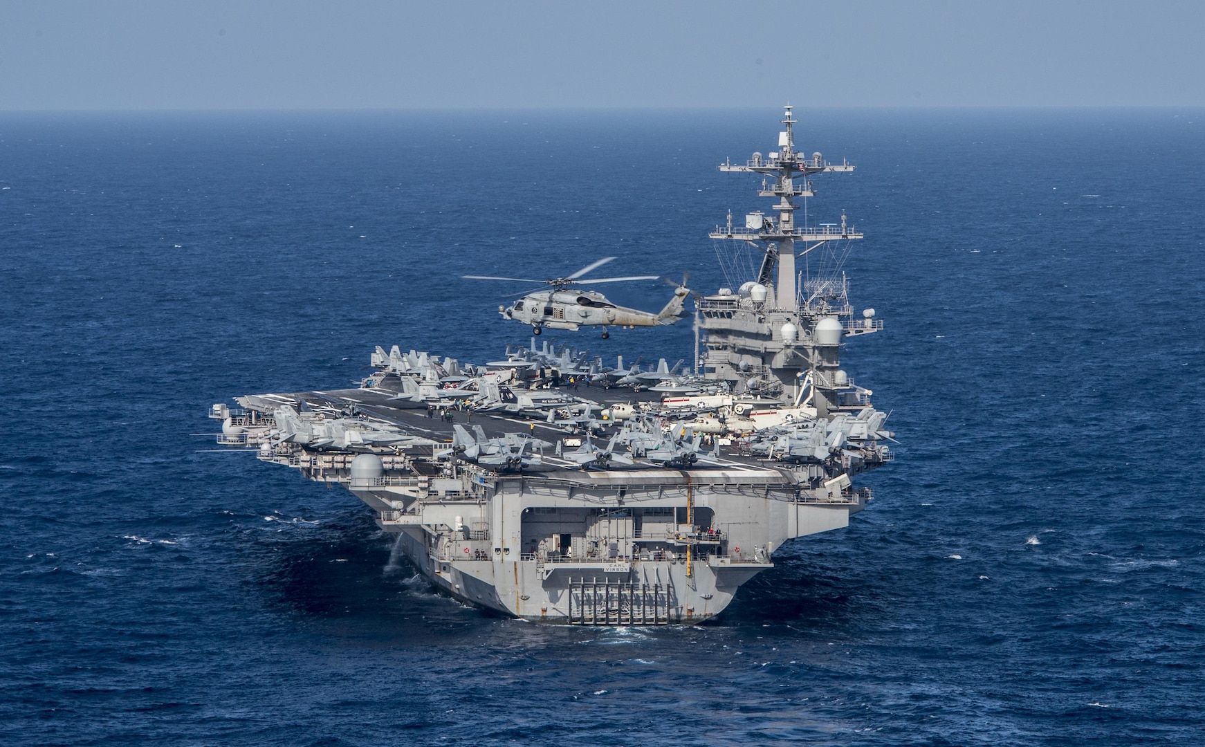 An MH-60R Sea Hawk from the Helicopter Maritime Strike Squadron (HSM) 78 “Blue Hawks” flies near the aircraft carrier USS Carl Vinson (CVN 70), April 24, 2017. U.S. Navy aircraft carrier strike groups have patrolled the Indo-Asia Pacific routinely for more than 70 years. 