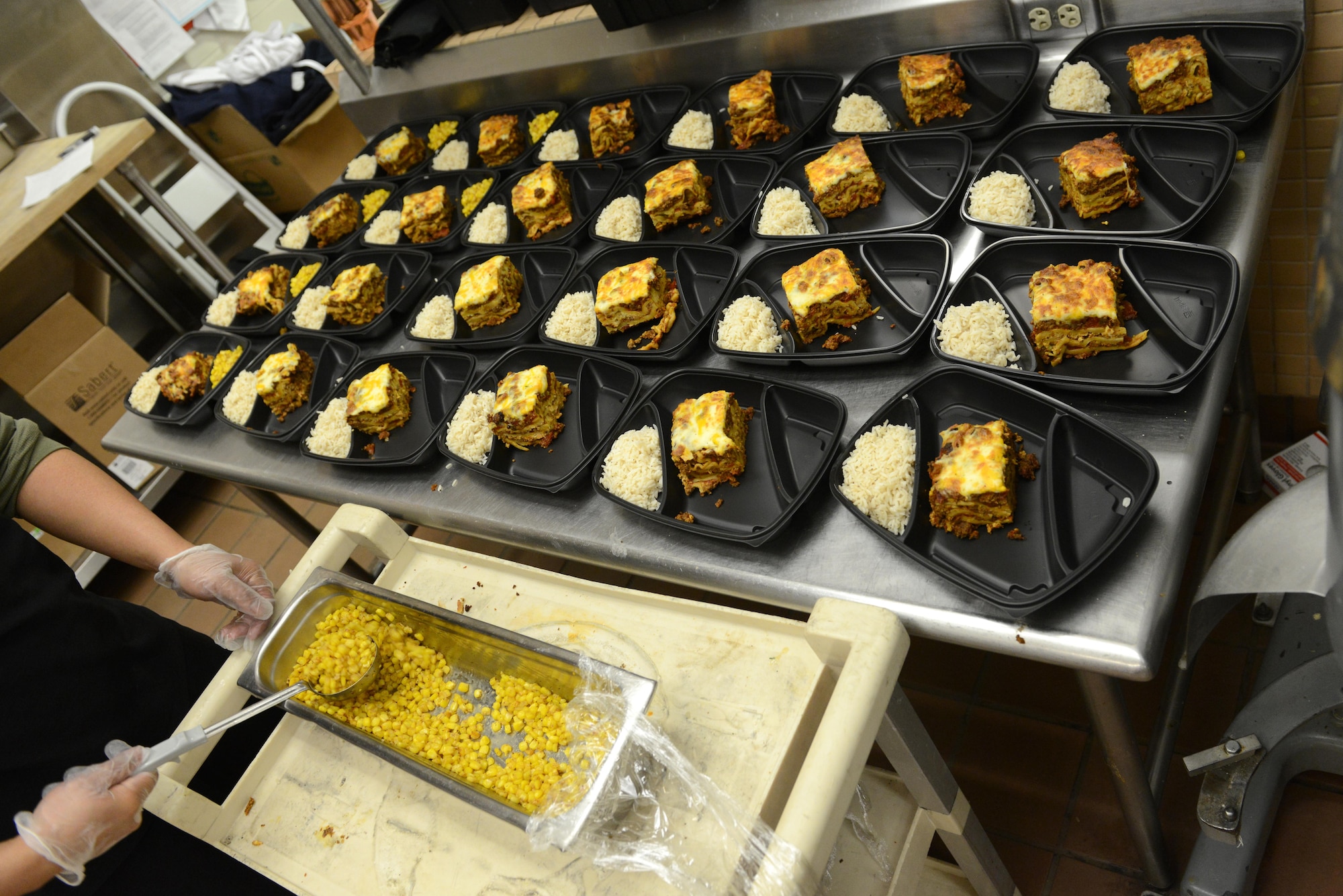 Rodel Magno, 673d Force Support Squadron Iditarod Dining Facility cook, serves corn in to-go containers for the Provisions on Demand at Joint Base Elmendorf-Richardson, Alaska, April 25, 2017. The DFAC prepares breakfast, lunch and dinner for the POD every Monday through Friday and Unit Training Assembly weekends. 