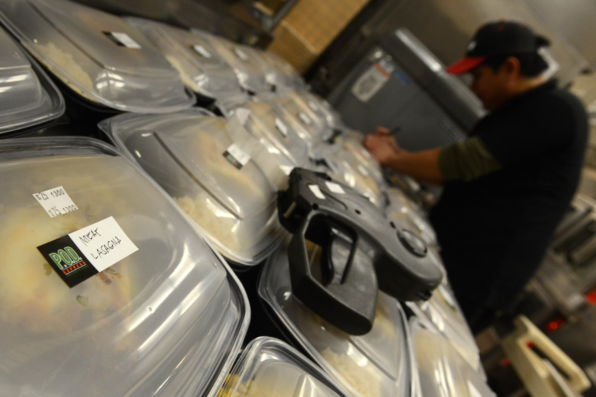 Rodel Magno, 673d Force Support Squadron Iditarod Dining Facility cook, writes the contents of the meal on to-go containers for the Provisions on Demand at Joint Base Elmendorf-Richardson, Alaska, April 25, 2017. The meals are in to-go containers because the POD’s primary customers are flightline personnel who do not have a lot of time and need hot meals. 