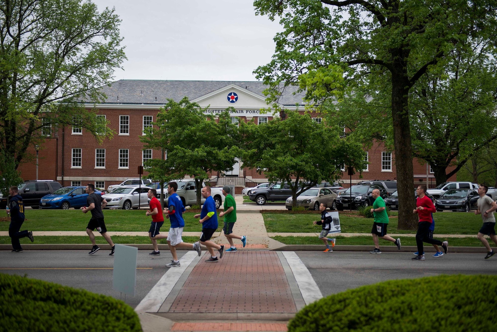 Members of Team Scott run past building P-4 during the Race Through Scott's Past, at Scott Air Force Base, Illinois, April 21, 2017. P-4 was originally built as a hospital during World War II and now serves as the headquarters building for 18th Air Force. (U.S. Air Force photo by Staff Sgt. Clayton Lenhardt)