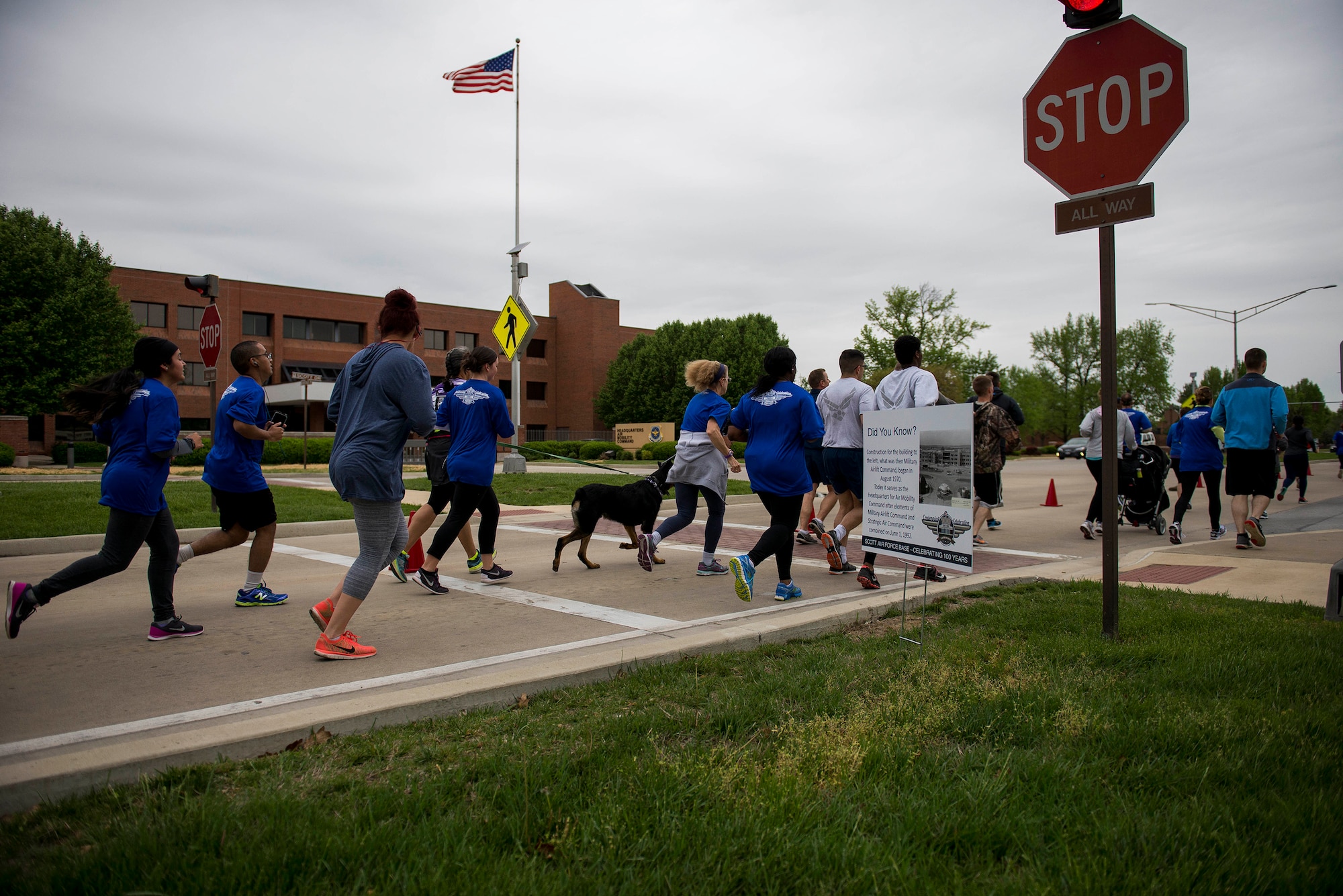 Members of Team Scott run past Air Mobility Command Headquarters during the Race Through Scott's Past, at Scott Air Force Base, Illinois, April 21. AMC was activated June 1, 1992, and is one of 10 major Air Force commands. (U.S. Air Force photo by Staff Sgt. Clayton Lenhardt)