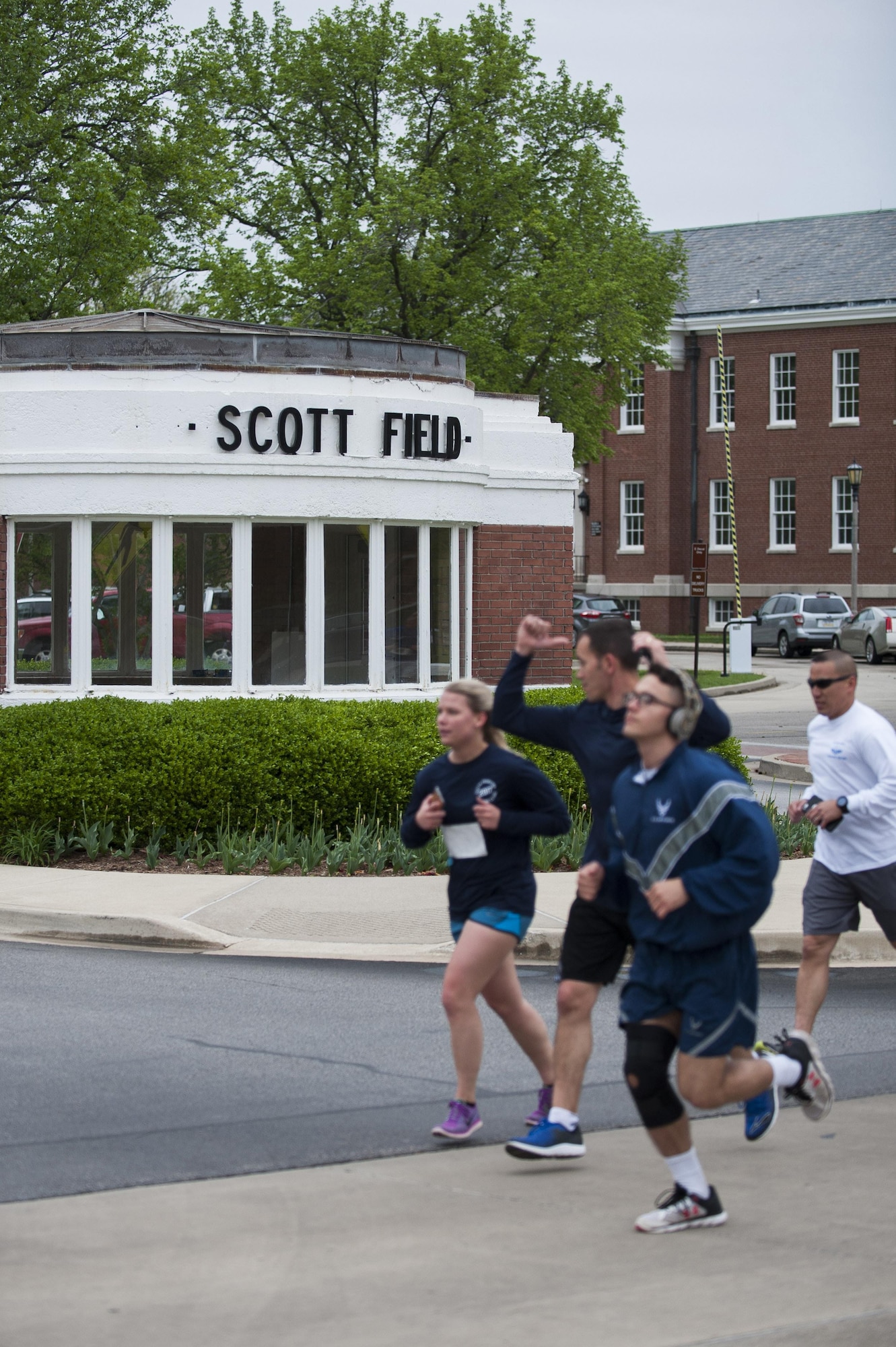 Members of Team Scott run past the old Scott Gate during the Race Through Scott's Past, at Scott Air Force Base, Illinois, April 21. This gate was the original entry point for Scott Field before the base was expanded. (U.S. Air Force photo by Staff Sgt. Clayton Lenhardt)