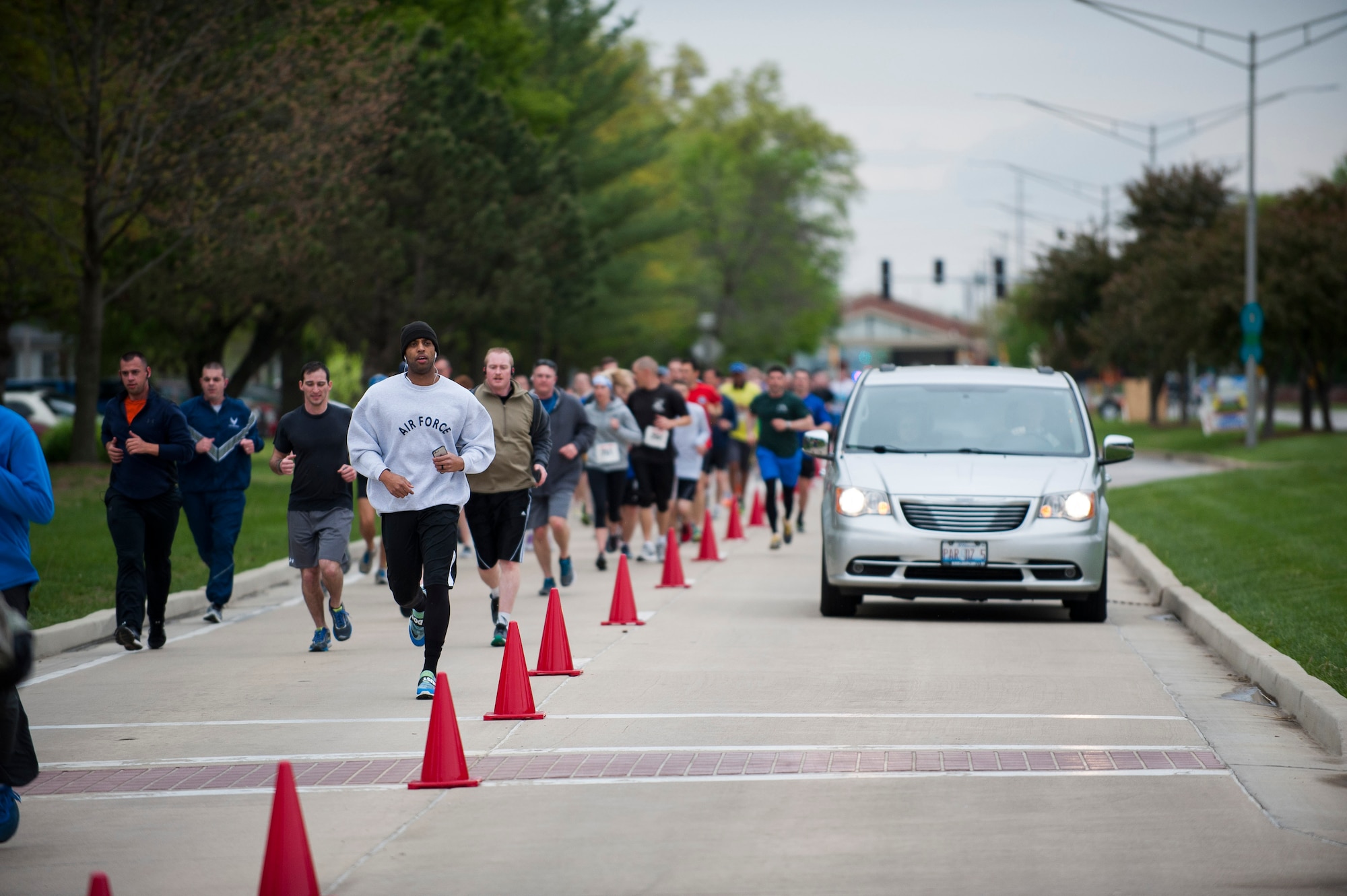 Members of Team Scott run down Scott Drive during the Race Through Scott's Past, at Scott Air Force Base, Illinois, April 21. The course took runners past several historic buildings on base. (U.S. Air Force photo by Staff Sgt. Clayton Lenhardt)