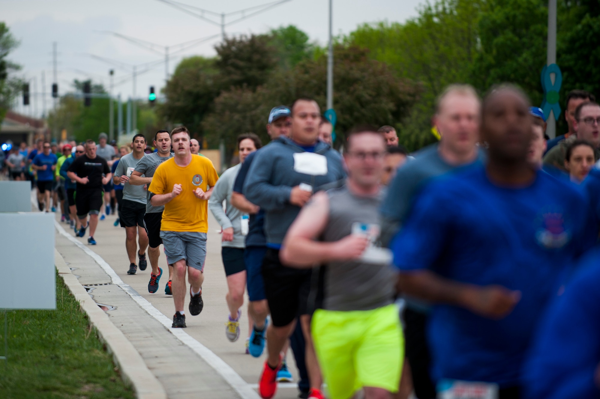 Members of Team Scott run down Scott Drive during the Race Through Scott's Past, at Scott Air Force Base, Illinois, April 21. The course took runners past several historic buildings on base. (U.S. Air Force photo by Staff Sgt. Clayton Lenhardt)