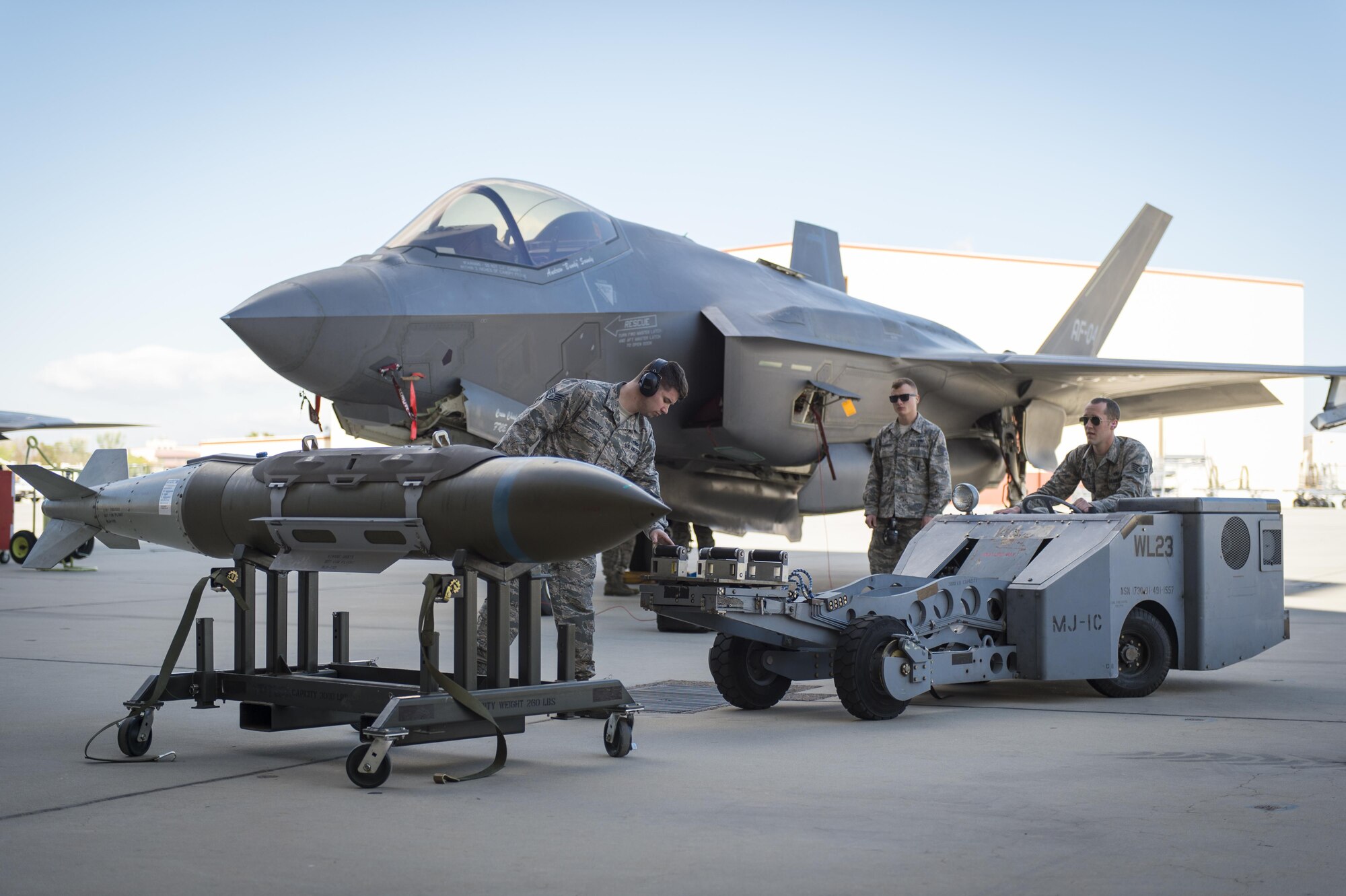 Pictured from left to right: Staff Sgt. Bobby Ambrose, Senior Airman Elijah Robinson and Staff Sgt. Jason Bucholtz prepare to load a GBU-31 bomb on an F-35 Lightning II April 3 during the 412th Maintenance Group's First Quarter Weapons Load Competition at Hangar 1600. (U.S. Air Force photo by Kyle Larson)