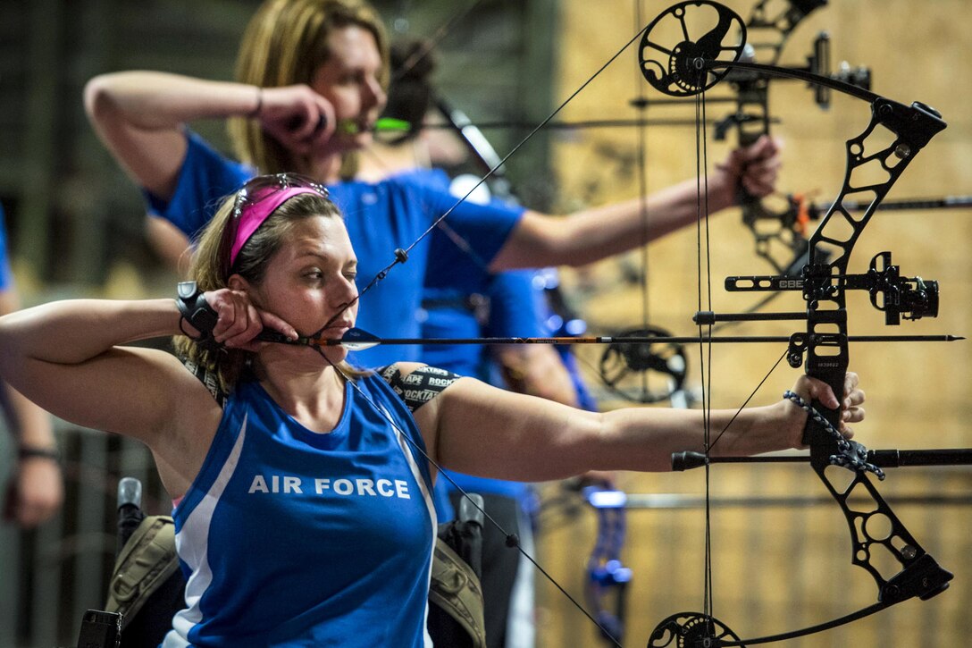 Warrior Games athletes Ashley Crites and Melinda Smith take aim during an archery session at the Air Force team’s training camp at Eglin Air Force Base, Fla., April 25, 2017. The weeklong Warrior Games training camp is the last team practice session before the yearly competition in June. Air Force photo by Samuel King Jr.