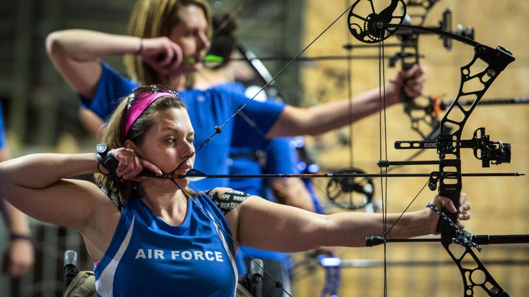 Warrior Games athletes Ashley Crites and Melinda Smith take aim during an archery session at the Air Force team’s training camp at Eglin Air Force Base, Fla., April 25, 2017. The weeklong Warrior Games training camp is the last team practice session before the yearly competition in June. Air Force photo by Samuel King Jr.