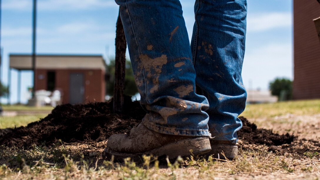 A 17th Civil Engineer worker plants a tree near the troop walk on Goodfellow Air Force Base, Texas, April 24, 2017. The tree planting was the base’s final act to wrap up Earth Day. (U.S. Air Force photo by 2nd. Lt. Joshua Foley/Released)