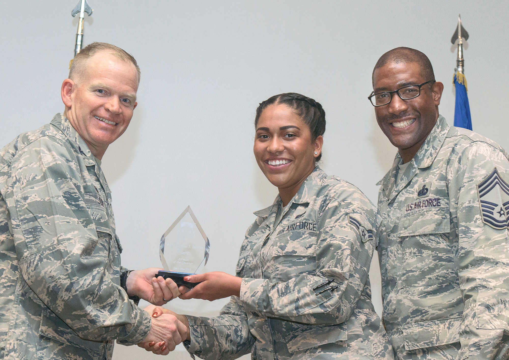 Airman 1st Class Lashai J. Battle, center, 71st Installation Support Squadron, receives the Airman of the Quarter award from Col. Darrell Judy, left, 71st Flying Training Wing commander, and Chief Master Sgt. Eric Dugger, 71st Mission Support Group superintendent, during a ceremony held April 25 in the Vance Air Force Base auditorium. (U.S. Air Force photo/ Terry Wasson)