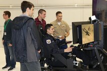 College students operate the new Marine Corps AH-1Z flight simulator during the 36 Annual Aerospace Conference and Career Fair at the University of North Dakota, April 20, 2017. According to the university’s website, SAMA invites prominent individuals from across the nation and from a variety of disciplines to join the students on campus and share their invaluable perspectives. (U.S. Marine Corps photo by Sgt. Jennifer Webster/Released)